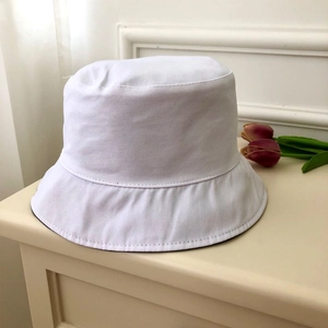Detail of white cotton bucket hat with black lining and premium stitched twill texture