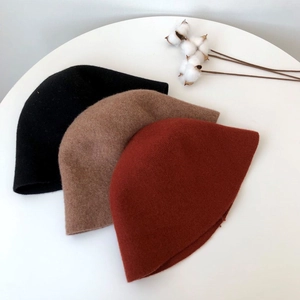 Knitted wool bucket hats in black, camel and brick red for autumn and winter