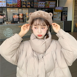 Detailed view of plush brown bear ear headband and beige hooded padded jacket collar