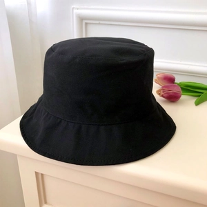 Close-up of black cotton bucket hat with focus on twill fabric texture and neat stitching