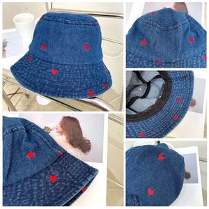 Detail view of denim bucket hat with red heart embroidery and internal sweatband