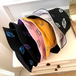 Minimalist double-sided bucket hats with butterfly prints in black, yellow, and pink colors