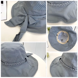 Detail of grey-blue striped sun hat showing adjustable inner drawstring and bow