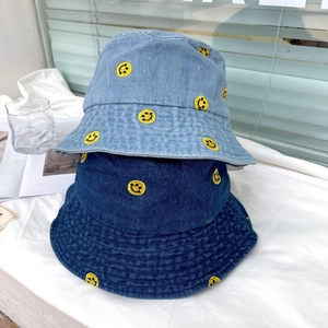 Japanese style denim bucket hats in light and dark blue with yellow smiley face embroidery