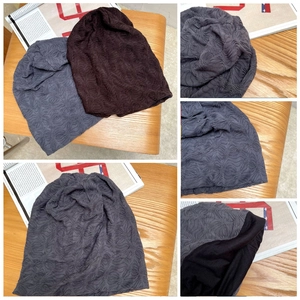 Detail der wellenförmigen Faltenstruktur und Innenfutter bei modischen Beanie-Mützen