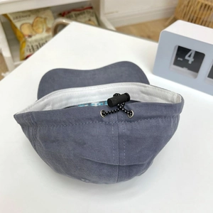 Detail of navy cotton cap showing black elastic drawstring adjustment and sweatband