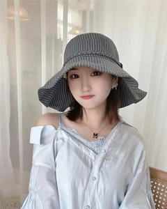 Detailed view of dark grey striped sun hat with elegant woven decorative band