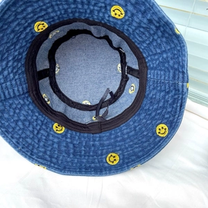 Detailed interior of denim bucket hat showing sweatband and adjustable drawstring
