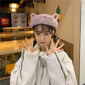 Detailed close-up of a purple plush hat featuring cute cat ear design for autumn and winter