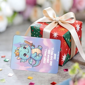 Macro view of blue dragon inspirational card with motivational quote on a red gift box