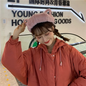 Detail of sweet pink plush beret with cute animal ears on a female model in winter