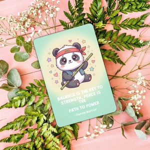 Close-up of panda warrior card with motivational quote on pink wood and floral background
