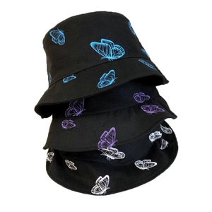 Three black cotton bucket hats with blue, purple, and white butterfly print on plain white background