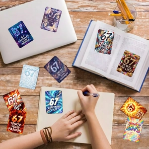 Macro detail of eleven trendy motivational 67-theme stickers on a wooden desk setup