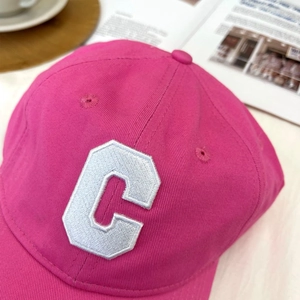 Detail of premium magenta cotton baseball cap with white 3D embroidered C logo