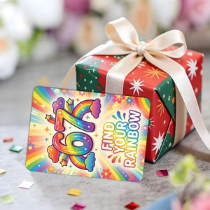 Macro view of motivational 'Find Your Rainbow' card next to a red gift box with ribbon