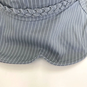 Close-up of blue wide-brim sun hat featuring white stripes and woven rope detail