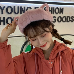 Sweet pink plush beret with cute animal ears shown on model in a trendy indoor fashion setting
