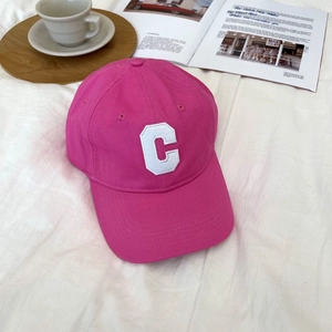 Rose pink cotton baseball cap with white C letter embroidery on white fabric background
