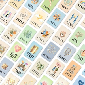 Set of 36 watercolor inspirational affirmation cards with positive quotes in a flat lay view