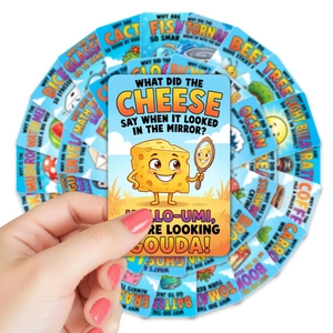 Close-up of colorful lunchbox notes with riddles and jokes for kids on white background