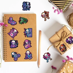 Lifestyle view of neon purple skull stickers on a notebook and gift box arrangement