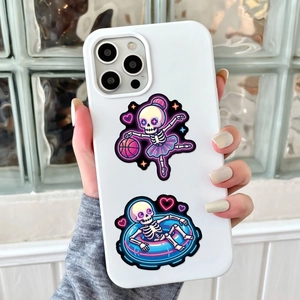 Detail of neon skeleton skull and pink heart stickers on a white iPhone case