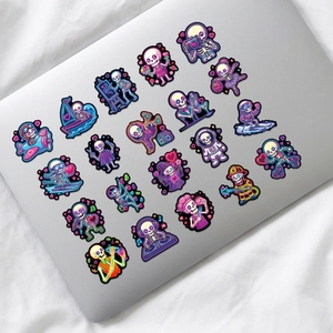 Detailed view of neon skull stickers with colorful characters on a silver laptop