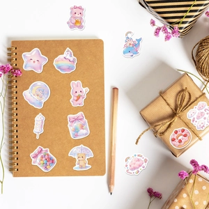 Pink candy cartoon stickers showing application on a notebook and gift box packaging