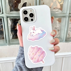 Detailed view of matte white silicone phone case with cute pink candy and rabbit stickers