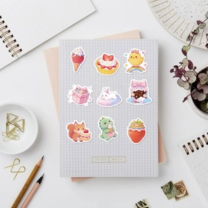 Close-up of cute pink candy themed stickers on a grid notebook with creative dessert designs