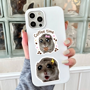 Close-up of cute cartoon hamster stickers on a white smartphone case held by hand