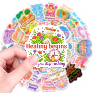 Close-up of healing mental health sticker with hourglass and positive quote on matte PVC