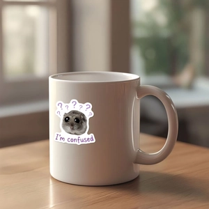 White ceramic hamster mug with funny confused expression on a rustic wooden desk