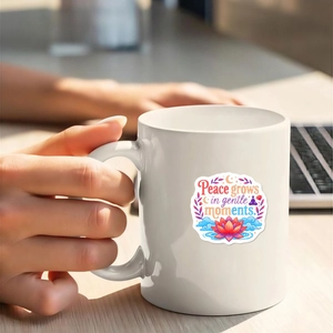 Macro view of waterproof stickers on white ceramic mug with positive quotes