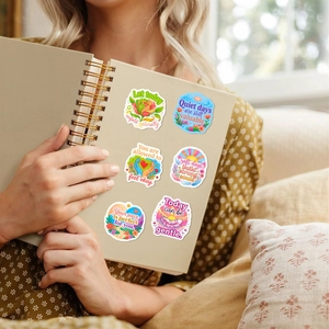 Detail of 6 mental health stickers with inspirational quotes on a laptop