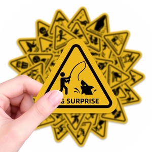 Close-up of funny yellow warning stickers with shark illustration and G Surprise text