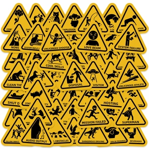 Flat lay of multiple yellow triangular warning stickers with humorous safety icons