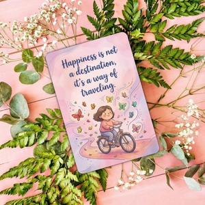 Detail of pink card with girl on bike illustration and happiness travel quote