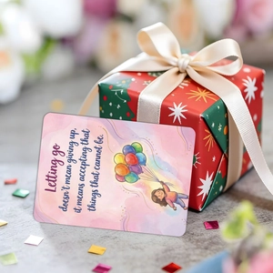 Detail of inspirational affirmation card with hand-drawn girl and red gift box with ribbon