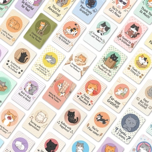 Detailed flat lay of colorful cartoon cat thank you cards with playful puns and illustrations