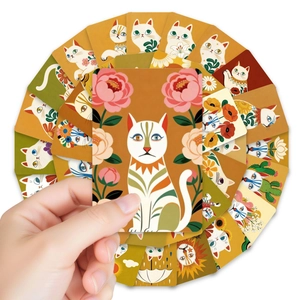 Close-up of bohemian style cat art cards with floral elements and hand-drawn patterns