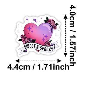 Macro detail of heart-shaped Sweet and Spooky gothic sticker with roses and bat motifs