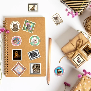 Detail of vintage cat art stickers on craft paper notebook and gift packaging