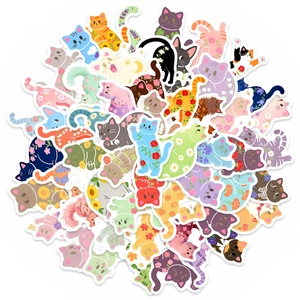 Flat lay of multiple waterproof cartoon cat stickers with floral patterns and vibrant designs