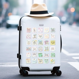 Close-up of waterproof inspirational quotes stickers on white suitcase luggage surface