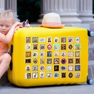 Vintage cat art stickers featuring famous paintings applied on a bright yellow suitcase