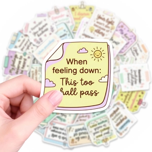 Close-up of inspirational quotes sticker with sun and clouds on a pastel background