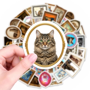 Close-up of vintage cat art stickers with a detailed golden framed tabby cat portrait