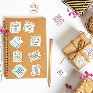 Close-up of healing English inspirational stickers with hand-drawn designs for notebooks